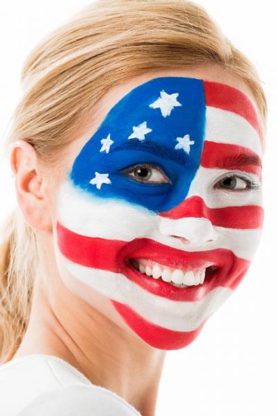 a woman with 4th of july face paint in the design of an american flag