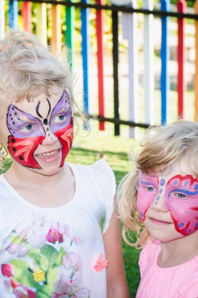 two girls with butterfly face paint